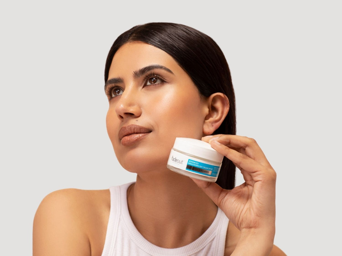 Two woman holding the Pure Glow Range by Fade Out