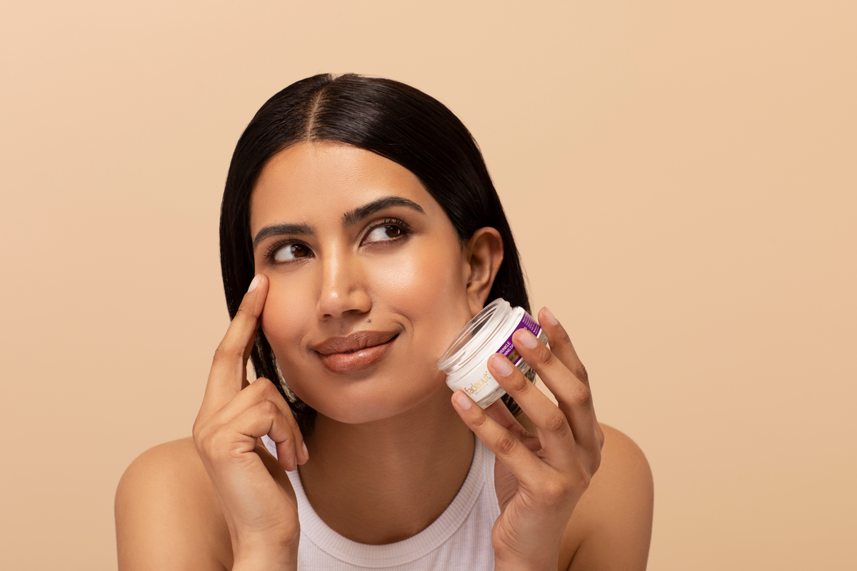 model putting cream on their face